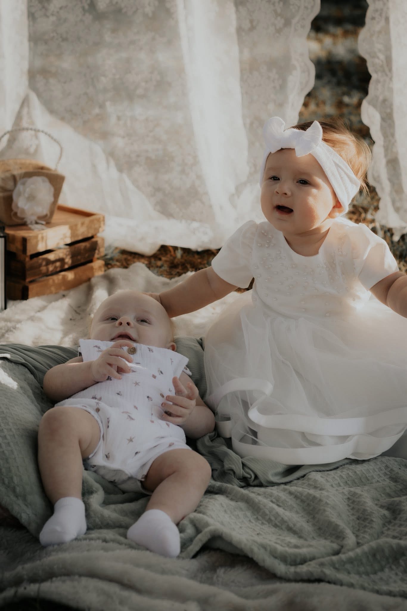 Two babies together during a sweet seasonal photography setup
