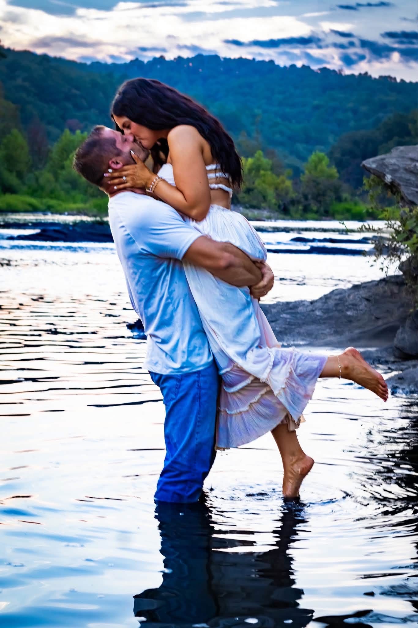 Couple sharing a beautiful embrace beside a river